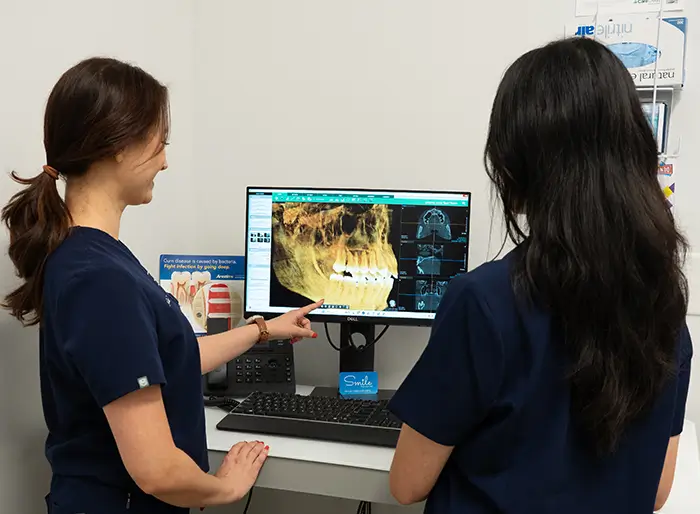 Two dental hygienists viewing a head x-ray.